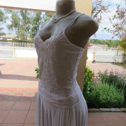 Embellished slip it over strappy top. For evening or day wear. Size 32 to 34. New condition.