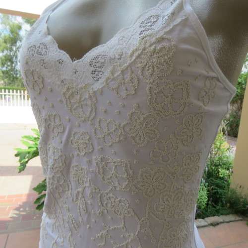 Embellished slip it over strappy top. For evening or day wear. Size 32 to 34. New condition.