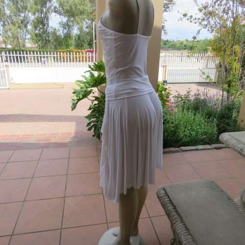 Embellished slip it over strappy top. For evening or day wear. Size 32 to 34. New condition.