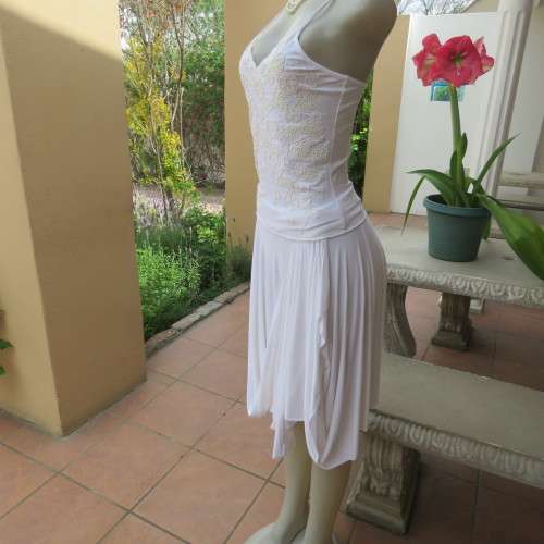Embellished slip it over strappy top. For evening or day wear. Size 32 to 34. New condition.