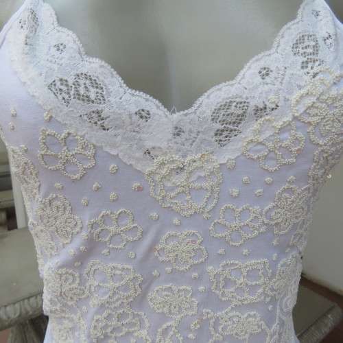 Embellished slip it over strappy top. For evening or day wear. Size 32 to 34. New condition.