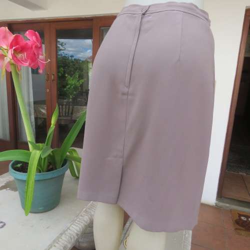 Smart medium brown knee length pencil skirt. Zip at back. Size 38/14 by DIJON. New condition.