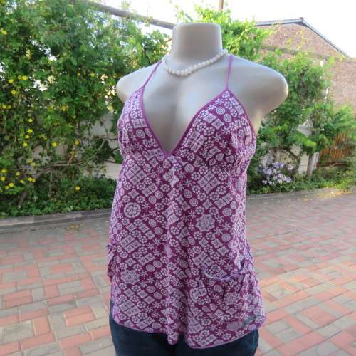 As new`Billabong`strappy top in size 38/14. In violet and white floral pattern.Unique strappy detail