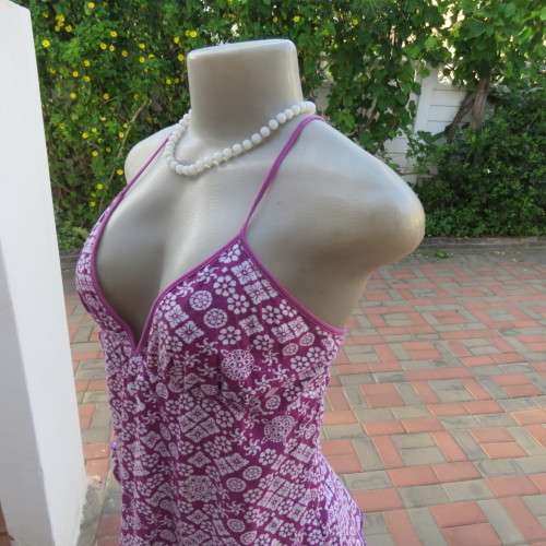 As new`Billabong`strappy top in size 38/14. In violet and white floral pattern.Unique strappy detail