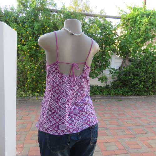 As new`Billabong`strappy top in size 38/14. In violet and white floral pattern.Unique strappy detail
