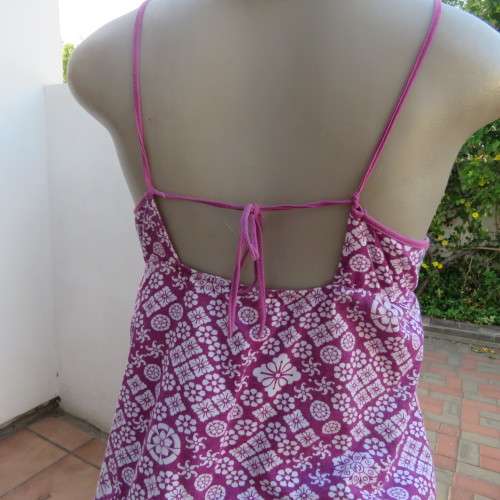 As new`Billabong`strappy top in size 38/14. In violet and white floral pattern.Unique strappy detail