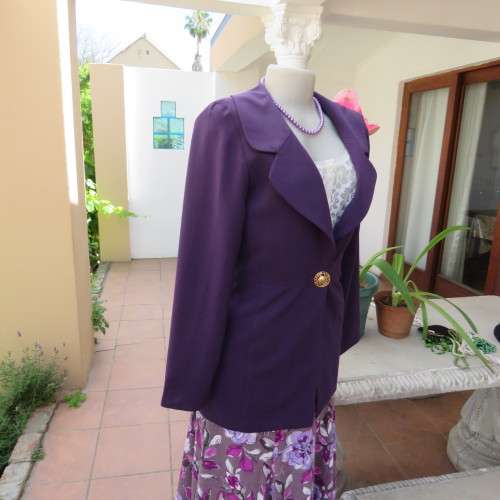 Elegant dark purple long sleeve jacket. Fully lined. By `Truworths`. In size 32/8. New condition.