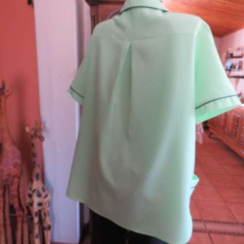 Lime green short sleeve top. Round collar. Size 46 to 48. By . Good condition.