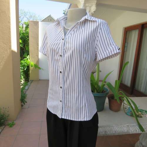 Black and white vertical striped top. Button down front. By `Insync Formal`. Size 38/14. As new.