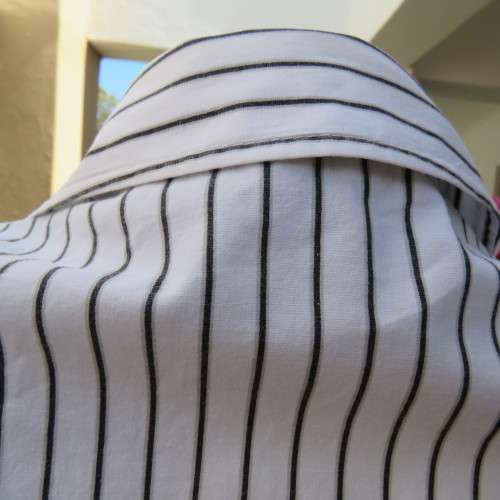 Black and white vertical striped top. Button down front. By `Insync Formal`. Size 38/14. As new.