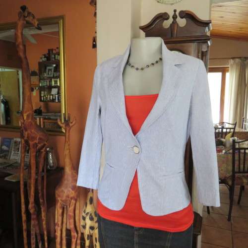 Chic tailored long sleeve jacket. In fine white and blue vertical stripes. Size 30/6. As new.