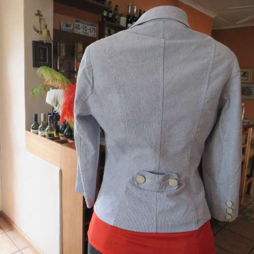 Chic tailored long sleeve jacket. In fine white and blue vertical stripes. Size 30/6. As new.