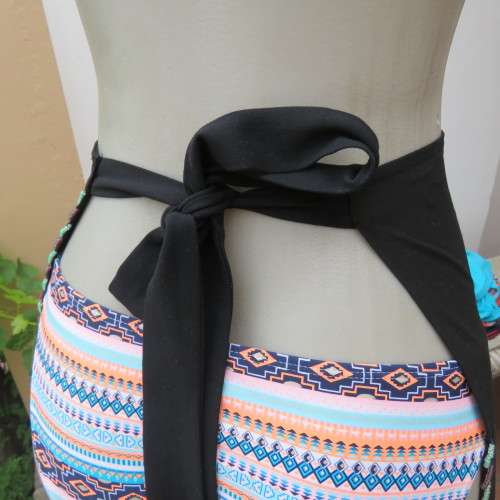 Ethnic style black apron. Bands to tie at back. With bead decoration edging. New condition.