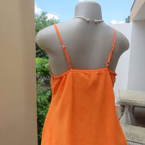 Lovely bright orange top. Thin adjustable straps. Pointed hemline. Size 36/12 by ` Shenga`. As new.