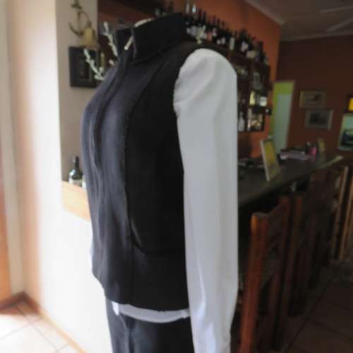 Warm black suede look  zip-up waistcoat. Polyester inner. Size 36/12 by `Woolworths`. New condition.