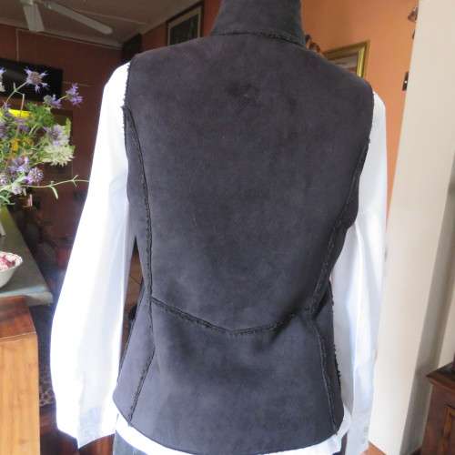 Warm black suede look  zip-up waistcoat. Polyester inner. Size 36/12 by `Woolworths`. New condition.