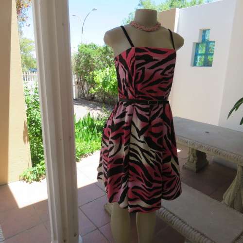 Up style sexy summer dress with pink, white and black print with belt. Size 34/10. New condition.
