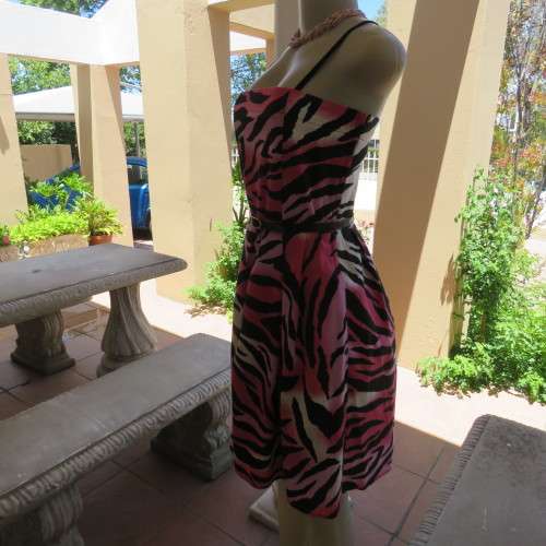 Up style sexy summer dress with pink, white and black print with belt. Size 34/10. New condition.