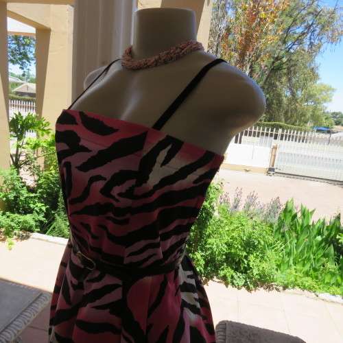 Up style sexy summer dress with pink, white and black print with belt. Size 34/10. New condition.