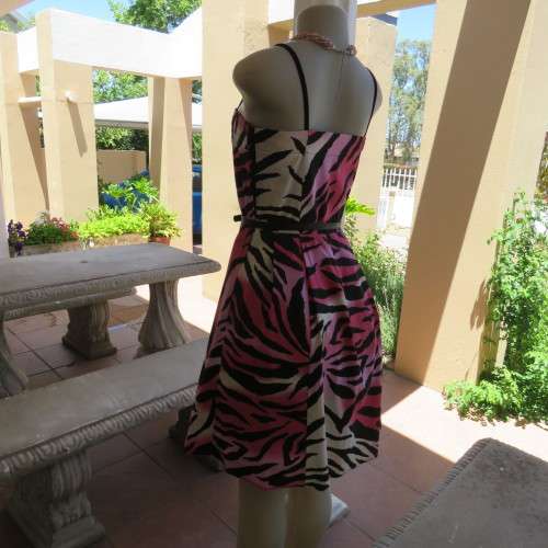 Up style sexy summer dress with pink, white and black print with belt. Size 34/10. New condition.