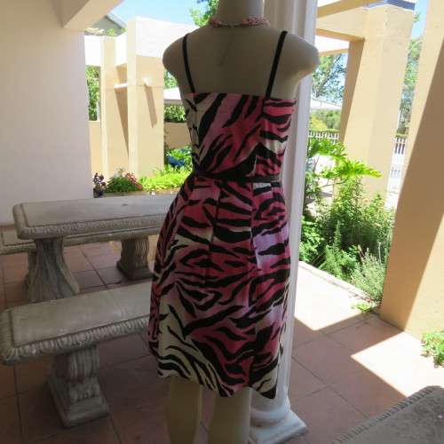 Up style sexy summer dress with pink, white and black print with belt. Size 34/10. New condition.