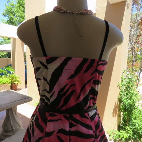 Up style sexy summer dress with pink, white and black print with belt. Size 34/10. New condition.