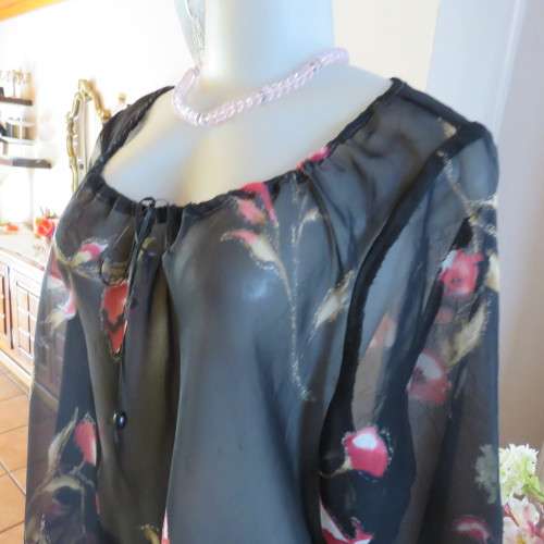 Sheer black top with pink floral pattern by `Topics` size 42/18. Used but fine for everyday use.