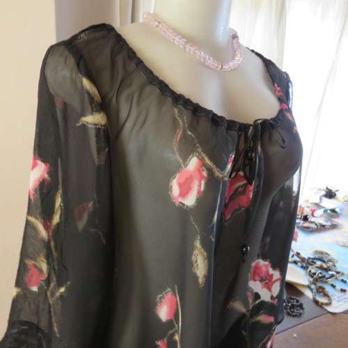 Sheer black top with pink floral pattern by `Topics` size 42/18. Used but fine for everyday use.
