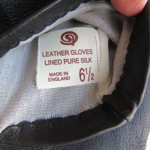 Pair of genuine leather black gloves lined with pure silk in size small 6.5.Made in England.As new