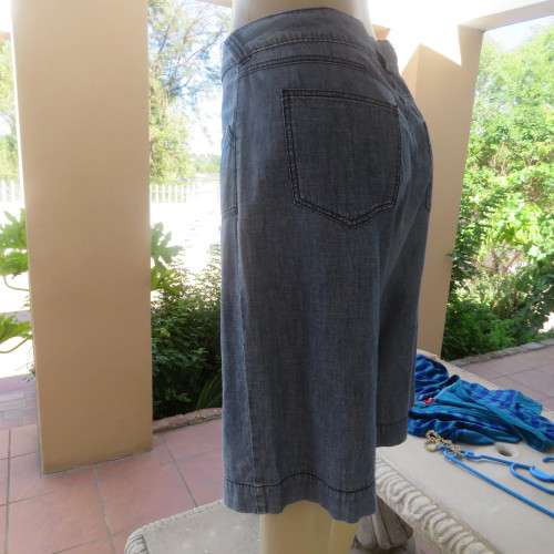 Light weight knee length denim shorts with pockets back and front. Size 38/14 by WOOLWORTHS.