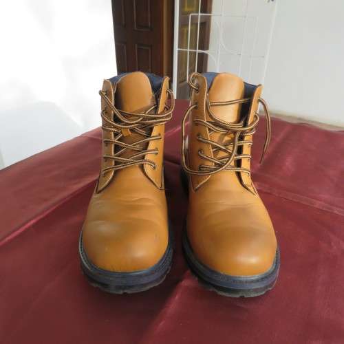 As new pair of tan colour size 4 boots for boys by (andUS). Laced up. Black inner and soles.