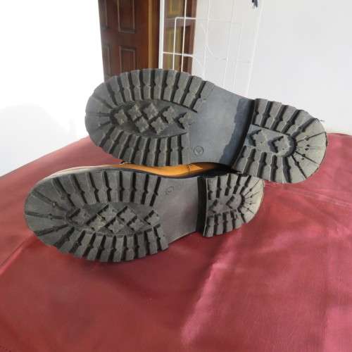 As new pair of tan colour size 4 boots for boys by (andUS). Laced up. Black inner and soles.