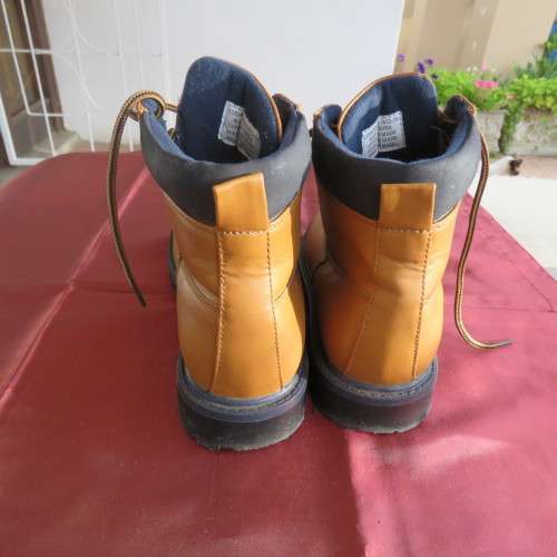 As new pair of tan colour size 4 boots for boys by (andUS). Laced up. Black inner and soles.