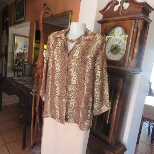 Animal print button down top in browns and cream with open collar. By TLC in size 40/16.As new