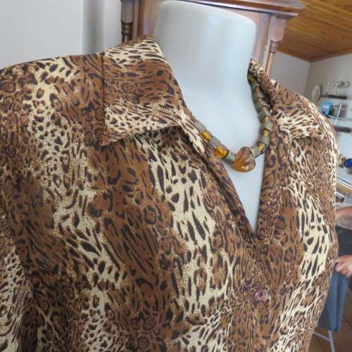 Animal print button down top in browns and cream with open collar. By TLC in size 40/16.As new