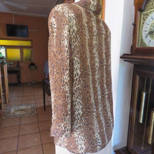 Animal print button down top in browns and cream with open collar. By TLC in size 40/16.As new