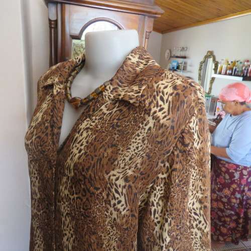 Animal print button down top in browns and cream with open collar. By TLC in size 40/16.As new