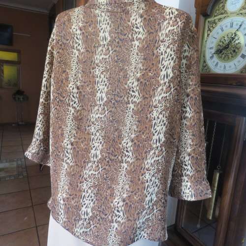 Animal print button down top in browns and cream with open collar. By TLC in size 40/16.As new