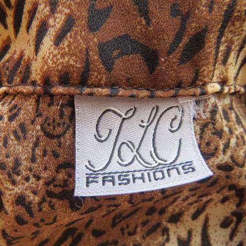 Animal print button down top in browns and cream with open collar. By TLC in size 40/16.As new