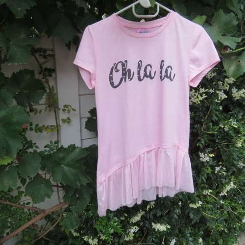 Pretty carnation pink capped sleeve slip over top with asymmetrical seamline. For 14 to 15 yr old.