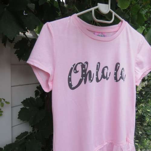 Pretty carnation pink capped sleeve slip over top with asymmetrical seamline. For 14 to 15 yr old.