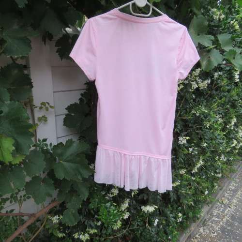 Pretty carnation pink capped sleeve slip over top with asymmetrical seamline. For 14 to 15 yr old.