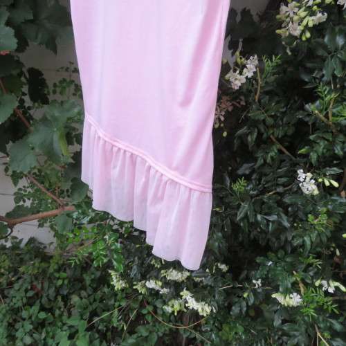 Pretty carnation pink capped sleeve slip over top with asymmetrical seamline. For 14 to 15 yr old.