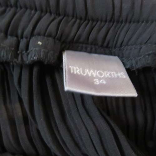 Smart black permanent pleated skirt with elasticated waist in size 34/10 by TRUWORTHS. As new