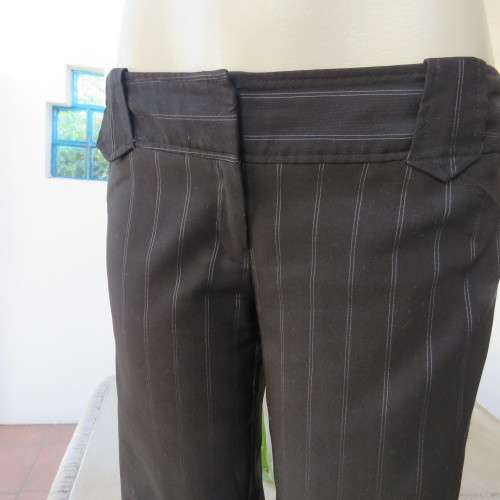 Elegant black straight legged pants with thin white vertical stripes.Low rise. Size 38/14. By W.W.W.