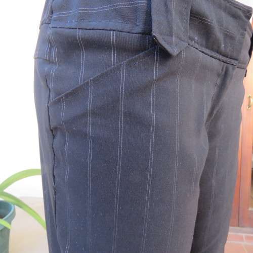 Elegant black straight legged pants with thin white vertical stripes.Low rise. Size 38/14. By W.W.W.