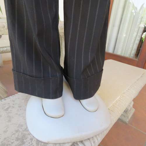 Elegant black straight legged pants with thin white vertical stripes.Low rise. Size 38/14. By W.W.W.