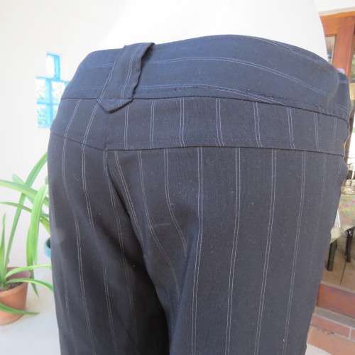 Elegant black straight legged pants with thin white vertical stripes.Low rise. Size 38/14. By W.W.W.