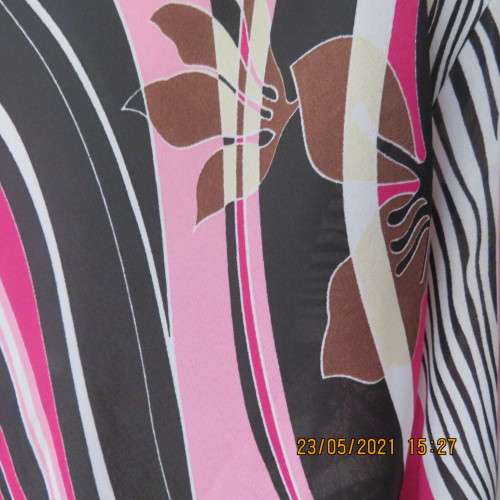 Get noticed in this top with diagonal patterned lines in pinks/black and white. By DONATELLA size 48