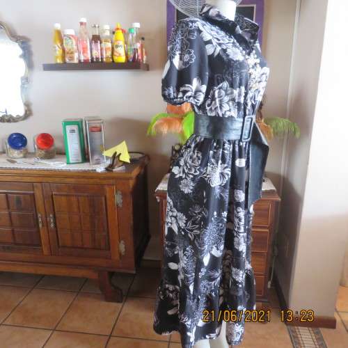 Pretty black and white floral 100% polyester dress with short sleeves.By OR size 34/10.Belt included